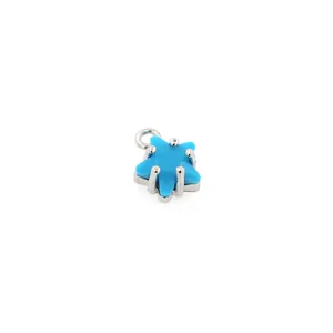 Close-up of light blue star pendant with silver claw setting and small hanging ring