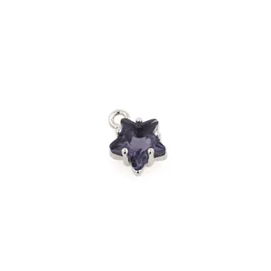 Macro view of 18K gold plated star pendant with purple zircon and four-prong setting