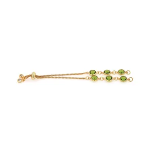 Detail of 18K gold-plated box chain bracelet with green gems and adjustable slide clasp