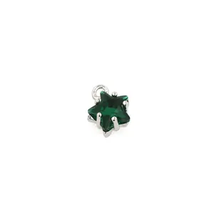 Detail of 18K gold plated star pendant with green zircon gemstone and silver setting