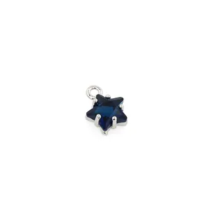 Macro shot of 18K gold plated star pendant with deep blue zircon and silver accents