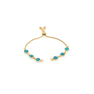 Detail of adjustable 18K gold-plated bracelet featuring six round blue crystal gemstones