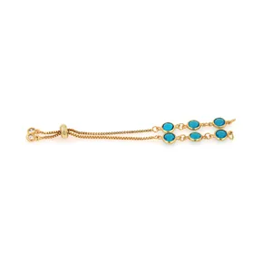 Macro detail of adjustable 18K gold plated bracelet with six round blue crystal gemstones