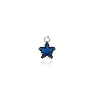Macro shot of 18K silver-plated star pendant with inlaid deep blue zircon stone