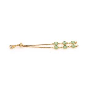 Detail of adjustable 18K gold-plated bracelet with six light green round gemstones