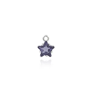 Macro shot of 18K gold plated star pendant with purple gemstone and zircon details