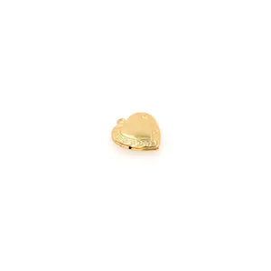 Close-up of vintage heart locket pendant with engraved edges in 18K gold plated brass