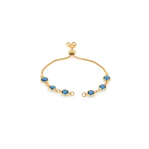 Close-up of 18K gold plated bracelet featuring round blue gems and adjustable slider clasp