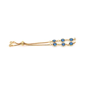 Macro view of adjustable 18K gold-plated double chain bracelet with blue zircons