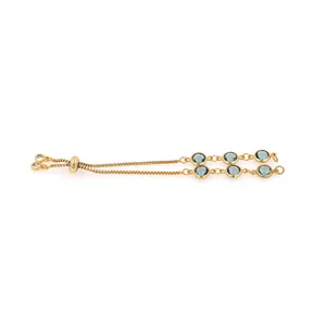 Detail of 18K gold plated friendship bracelet with blue faceted stones and box chain