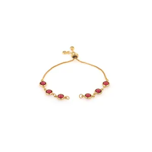 Detail of adjustable 18K gold plated bracelet with six round red crystal stones