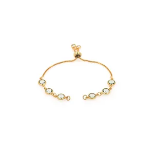 Detail of adjustable gold-plated bracelet featuring six round light green bezel-set stones