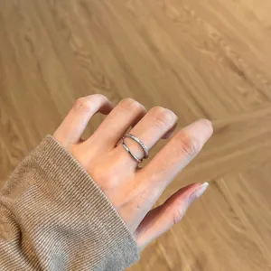 Close-up of a double-layer S925 silver ring featuring micro-paved cubic zirconia accents