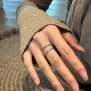 Double-layer sterling silver ring featuring cubic zirconia accents on a hand model