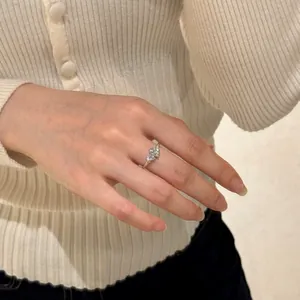 Elegant S925 silver ring featuring three heart-shaped stones worn on a finger