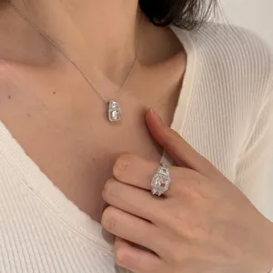 Close-up of S925 silver necklace and ring set with pink square high carbon diamonds
