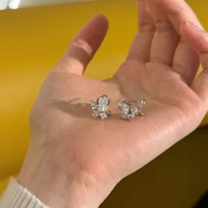 Detailed close-up of S925 silver earrings with pear and square cut zircon stones