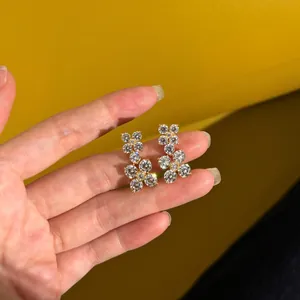 Sparkling S925 silver flower stud earrings with white cubic zirconia in gold finish