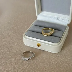 Macro detail of S925 sterling silver stamp on wavy crystal rings in a gift box