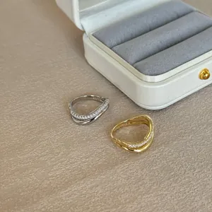 Detail view of S925 sterling silver stamp on double layered rings with paved diamonds