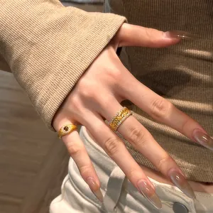 Detail of sunflower relief gold ring with diamonds and matte tiger eye stone ring set