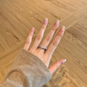 Close-up of a double-layered S925 silver ring featuring cubic zirconia pavé on a finger