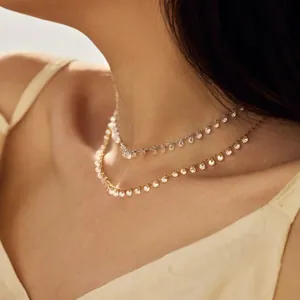 Elegant double-layered silver and gold necklace set with sparkling round zircon pendants