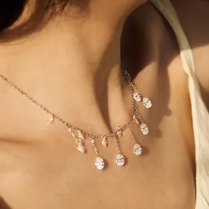 Elegant S925 silver tassel necklace featuring dangling oval cubic zirconia on model