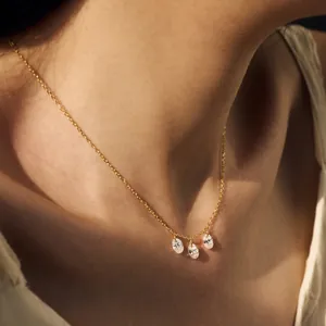 Golden S925 silver necklace with three oval zircon pendants worn by a model