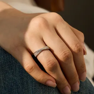 Cross-over S925 silver ring with pavé-set round zircon stones on a model's hand