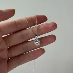 Vue détaillée du collier halo en moissanite argent S925 tenu en main pour montrer la taille