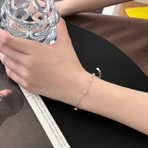 S925 silver bracelet featuring heart yellow stone and white zircons on a model wrist