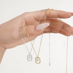 Close-up of octagon P initial pendants with white zircon stones in gold and silver finish