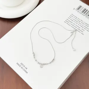 Close-up of S925 sterling silver necklace featuring a smile pendant and polished beads