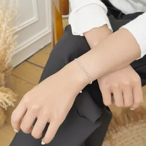 Wrist macro of S925 sterling silver minimalist paperclip chain and round bead bracelet