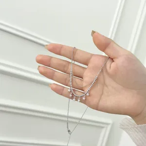 Double-layered S925 sterling silver star pendant necklace held in hand