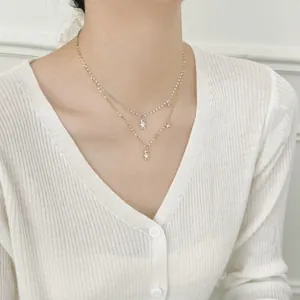 S925 silver double-layered teddy bear necklace with star charms on a model