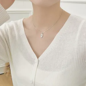 Close-up of S925 sterling silver star pendant on an irregular bamboo chain on neck