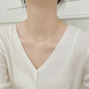 Minimalist S925 sterling silver heart necklace worn with a white V-neck sweater