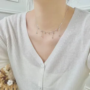 Delicate S925 sterling silver beaded tassel necklace worn as a minimalist choker