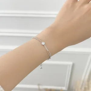 Detail of S925 sterling silver paperclip bead bracelet with zircon on female wrist