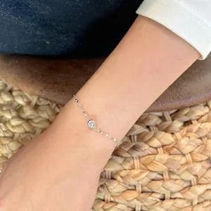 Detail of minimalist S925 sterling silver chain bracelet with a bezel-set moissanite stone