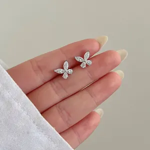 Macro shot of S925 sterling silver butterfly stud earrings with sparkling moissanite diamonds
