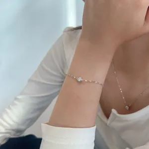 Macro shot of minimalist S925 sterling silver bracelet with round moissanite inlay