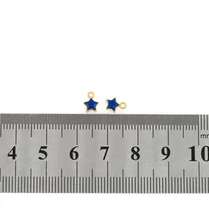Blue enamel star pendants measured with a ruler to show 10mm width for DIY jewelry making