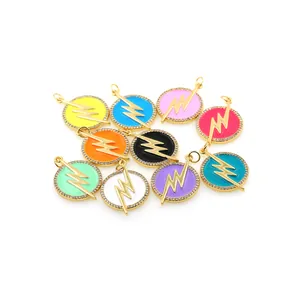 Dettaglio macro di ciondoli a fulmine placcati oro 18K con smalto colorato e zirconi