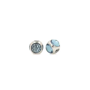 Macro detail of 18K gold plated silver beads with light blue zircon stones for DIY jewelry