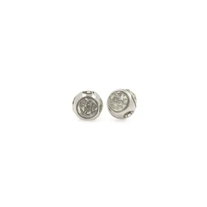 Macro shot of silver circular charms with clear cubic zirconia for DIY bracelets