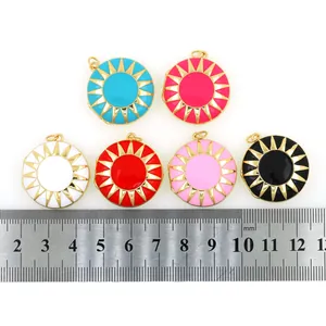 Detail view of 20mm round sunburst enamel pendants with a ruler for size measurement