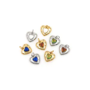 Macro shot of 18K gold heart charms with colorful zircon stones and crystal details